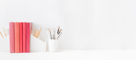 Home office desktop with books, office supplies on a light backgroundの写真素材