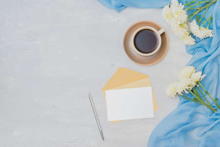Workspace wedding invitation with a scarf, white flowers on a light backgroundの写真素材