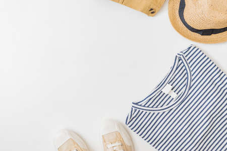 Flat lay summer composition with straw hat and sneakers on a white backgroundの写真素材