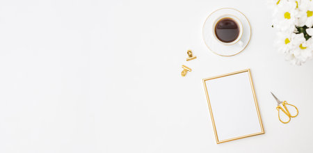 Flat lay mockup golden frame, white flowers, cup of coffee on a white backgroundの写真素材