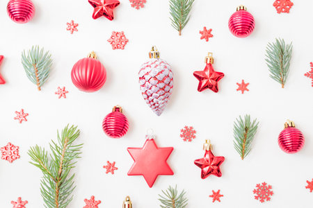 Flat lay pattern with fir branches, christmas balls and decorations on a white backgroundの写真素材