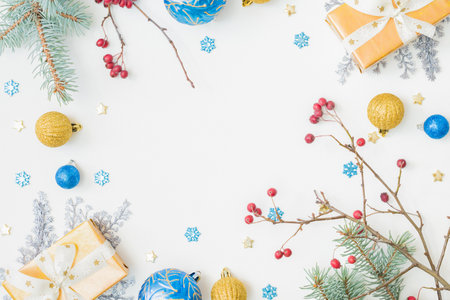 Flat lay frame with christmas balls, fir branches, snowflakes and gift box on a white background. Merry christmas card and copy space for your textの写真素材
