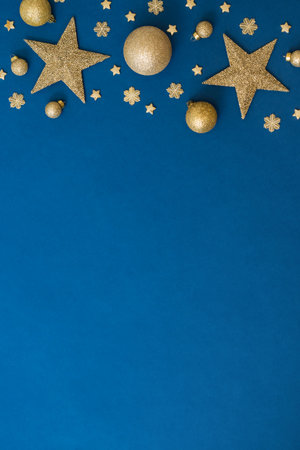 Christmas holiday banner background with copyspace. Flat lay frame with christmas balls and decorations on a blue backgroundの写真素材