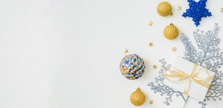 Flat lay frame with christmas balls and gift box on a white background. Christmas and New Year banner with copy space for your textの写真素材
