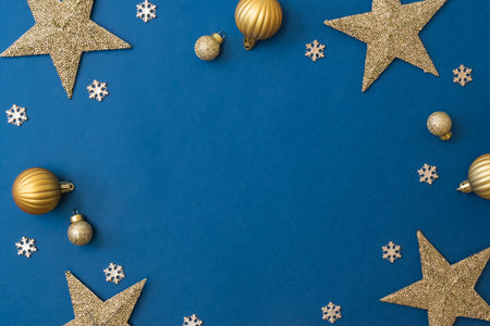 Christmas holiday composition. Flat lay frame with christmas balls and decorations on a blue backgroundの写真素材