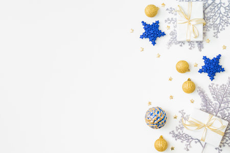 Flat lay frame with christmas balls and gift box on a white background. Merry christmas card and copy space for your textの写真素材