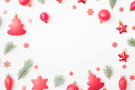 Flat lay frame with fir branches, christmas balls and decorations on a white backgroundの写真素材