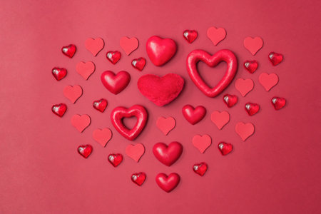 Flat lay valentines day pattern with red hearts on a red background. valentine's day greeting cardの写真素材