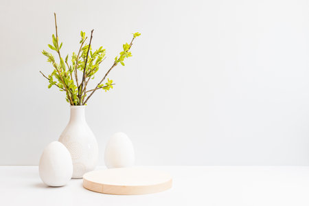 Willow branches in a vase and easter eggs on a light background. Easter background with copy spaceの写真素材