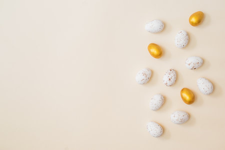 Flat lay easter composition with easter eggs on beige backgroundの写真素材