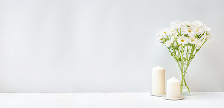 Home interior decor elements. White flowers in a vase on a light backgroundの写真素材