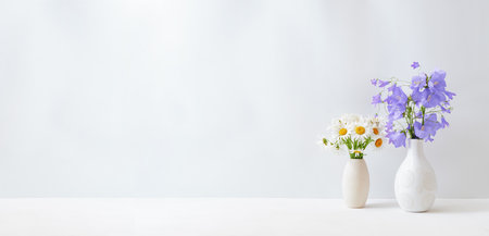 Wildflowers in a vase on a white table. Mock up for display worksの写真素材