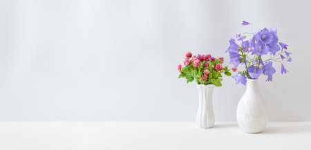 Wildflowers in a vase on a white table. Mock up for display worksの写真素材