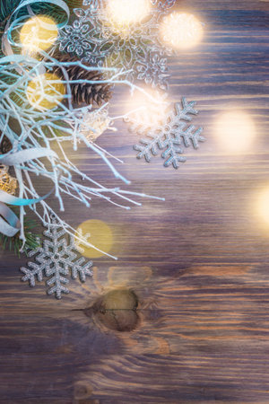 Flat lay christmas composition with white branches and christmas decorations on a wooden table. Winter merry christmas holiday greeting cardの写真素材