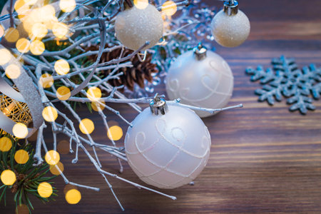 Christmas composition with white branches and Christmas ball on a wooden table. Winter merry christmas holiday greeting cardの写真素材