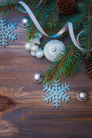 Flat lay christmas composition with fir branches and christmas decorations on a wooden table. Winter holiday background with copy spaceの写真素材