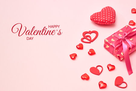 Valentines day frame with gift box and red hearts on a pink background. Happy Valentine's Day celebration textの写真素材