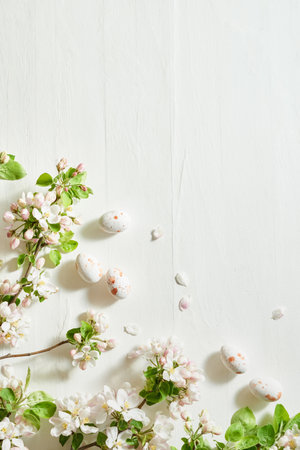 Holiday composition with spring flowers and easter eggs on a light background. Happy easter flat lay concept with copy spaceの写真素材