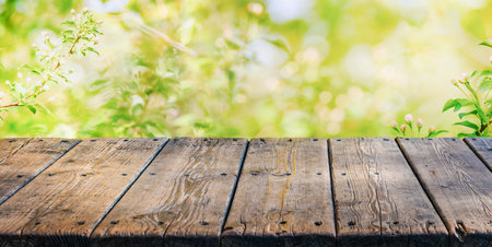 Empty old wooden table with spring bokeh background. Template mock up for display of productの写真素材