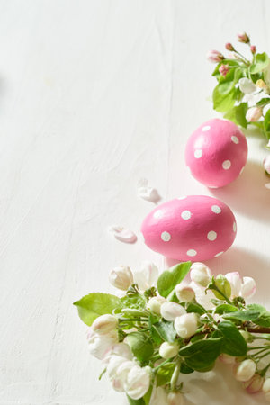 Holiday composition with spring flowers and easter eggs on a light background. Happy easter concept with copy spaceの写真素材