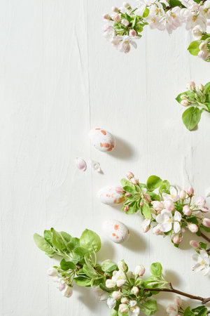 Holiday composition with spring flowers and easter eggs on a light background. Happy easter flat lay concept with copy spaceの写真素材