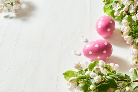 Holiday composition with spring flowers and easter eggs on a light background. Happy easter concept with copy spaceの写真素材