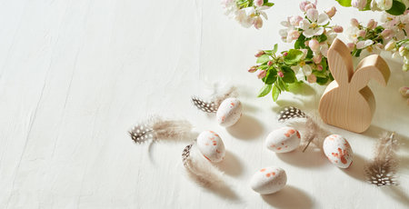 Holiday composition with spring flowers and easter eggs on a light background. Happy easter concept with copy spaceの写真素材