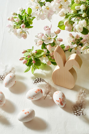 Holiday composition with spring flowers and easter eggs on a light background. Happy easter concept with copy spaceの写真素材