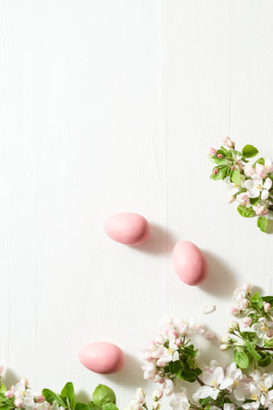 Holiday composition with spring flowers and easter eggs on a light background. Happy easter flat lay concept with copy spaceの写真素材