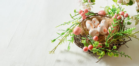 Easter eggs in a nest on a white background. Easter background with copy spaceの写真素材