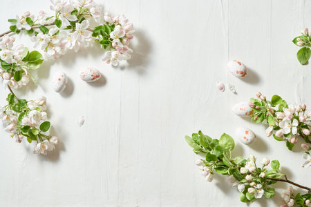 Holiday composition with spring flowers and easter eggs on a light background. Happy easter flat lay concept with copy spaceの写真素材