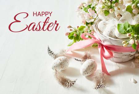 Holiday composition with spring flowers and easter eggs in basket on a light background. Happy Easter backgroundの写真素材