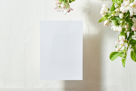 Mockup invitation or blank greeting card with spring flowers on a light backgroundの写真素材