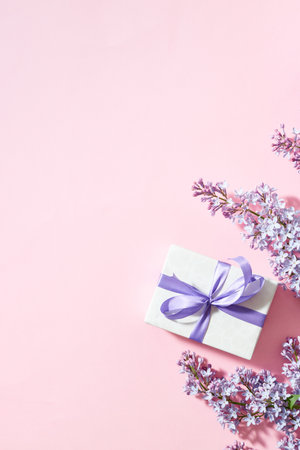 Lilac branches and gift box on a pink backgroundの写真素材