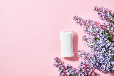 White antiperspirant deodorant with lilac branches on a pink backgroundの写真素材