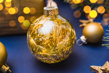 Christmas composition with christmas ball, garland, gift box on a blue background. Winter merry christmas holiday greeting cardの写真素材