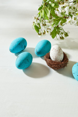 Holiday composition with spring flowers and easter eggs on a light background. Happy easter concept with copy spaceの写真素材