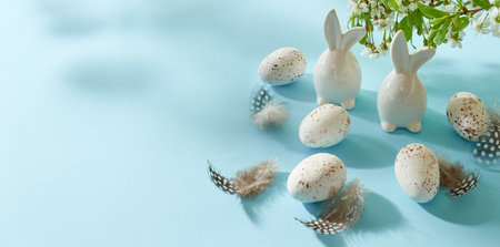 Holiday composition with spring flowers and easter eggs on a blue background. Happy easter concept with copy spaceの写真素材