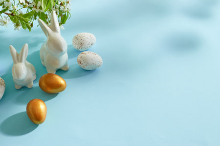 Holiday composition with spring flowers and easter eggs on a blue background. Happy easter concept with copy spaceの写真素材