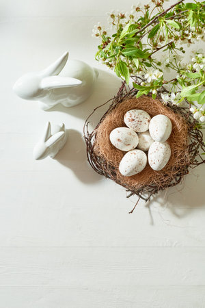 Holiday composition with spring flowers and easter eggs on a light background. Happy easter flat lay...