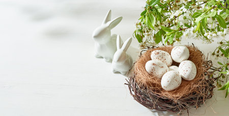 Holiday composition with spring flowers and easter eggs on a light background. Happy easter concept with copy spaceの写真素材