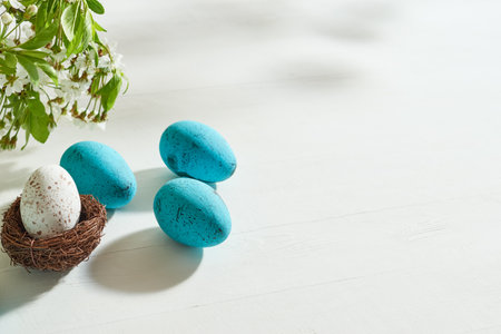 Holiday composition with spring flowers and easter eggs on a light background. Happy easter concept with copy spaceの写真素材