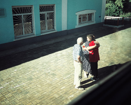 Couple of seniors walking on the street near the house in the summerの写真素材