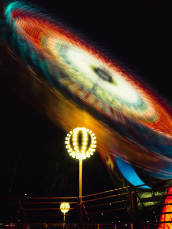 Amusement park at night, motion blur, close up.の写真素材