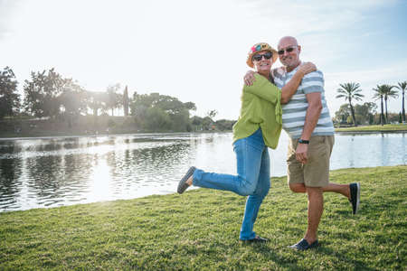 Happy retired couple in a parkの写真素材