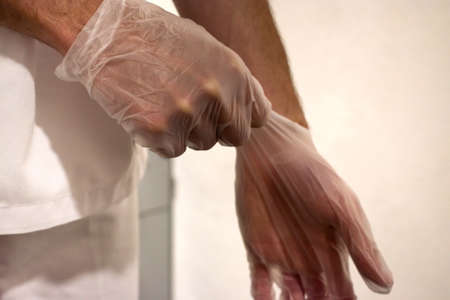 close-up of a male medical staff on latex glovesの写真素材