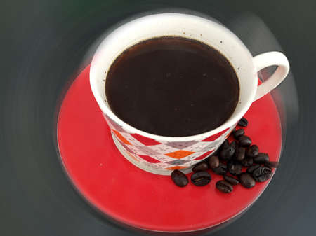 A cup of black morning coffee and raw coffee beans top view, high angle view. Fresh morning coffee...