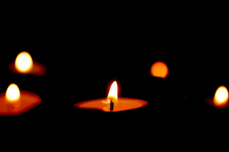 Candle light in the dark background. Be the light to the world concept.