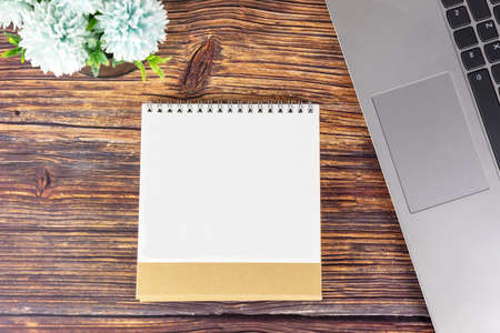 Laptop and notebook with blank page on wooden table. Mock upの写真素材