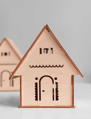 a toy wooden house isolated on a white background. A small plywood house in the Russian style. Handmade workの写真素材